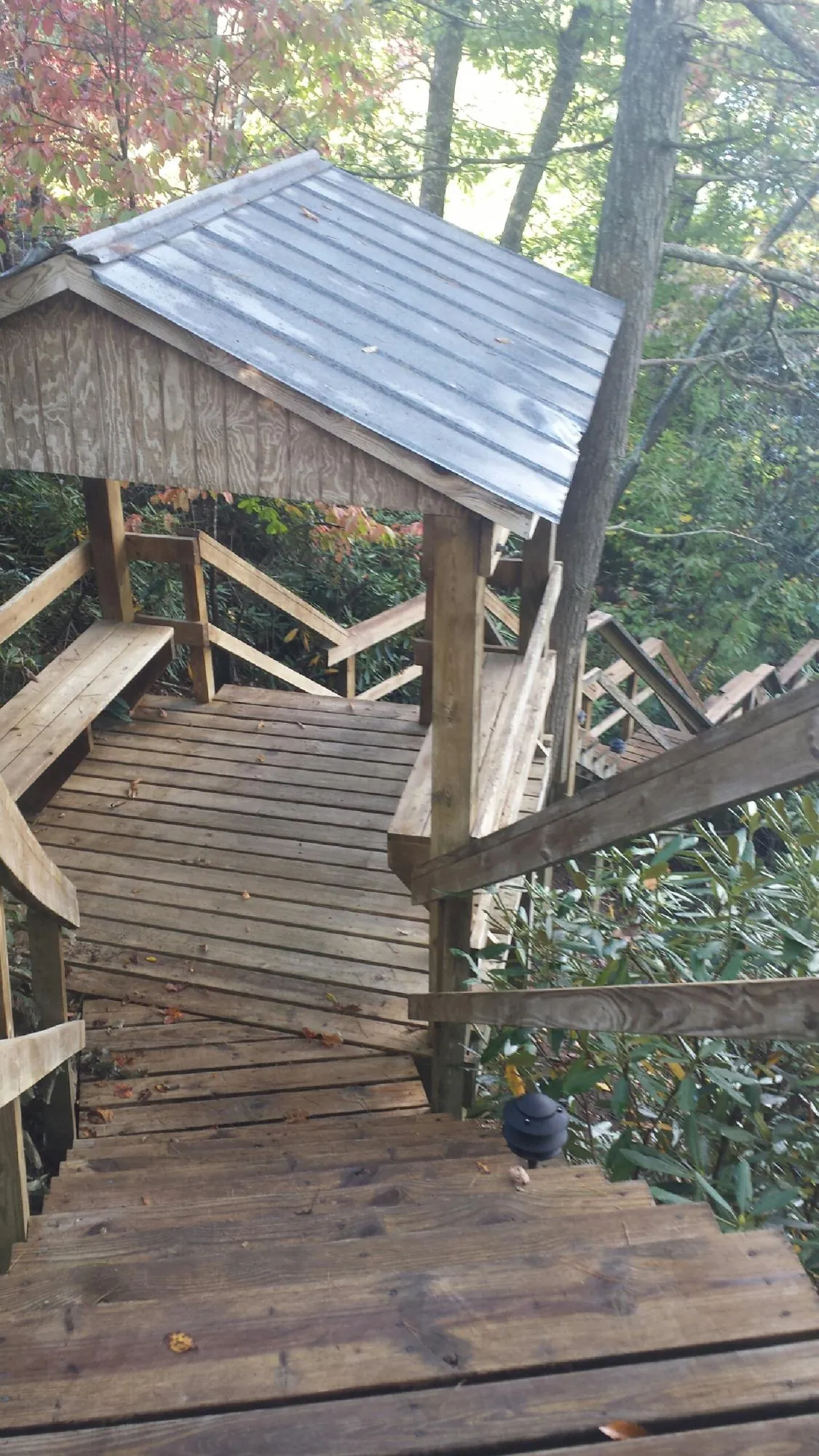 Metal roofed shelter over wooden steps on a wooded walkway — Skylight Repair & Installation work by our crew in East Hartland