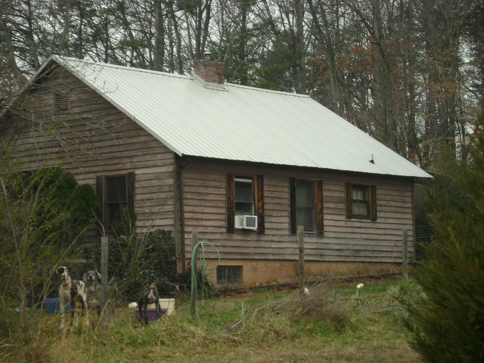White metal roof on an old wood sided farmhouse, from a Metal Roof Installation job in East Hartland